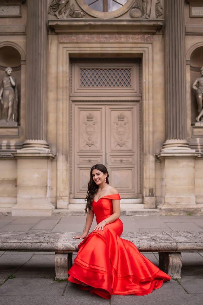 beautiful girl posing in red dress for quinceanera photo shoot