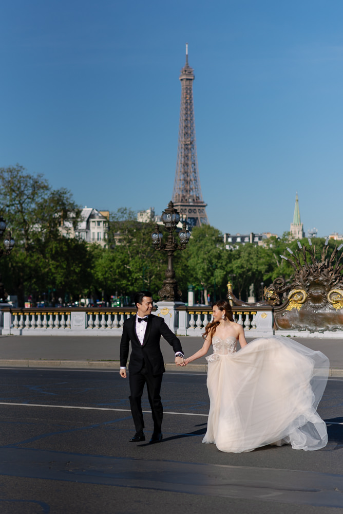Bride and groom crossing the street in one of the best eiffel tower spots in Paris