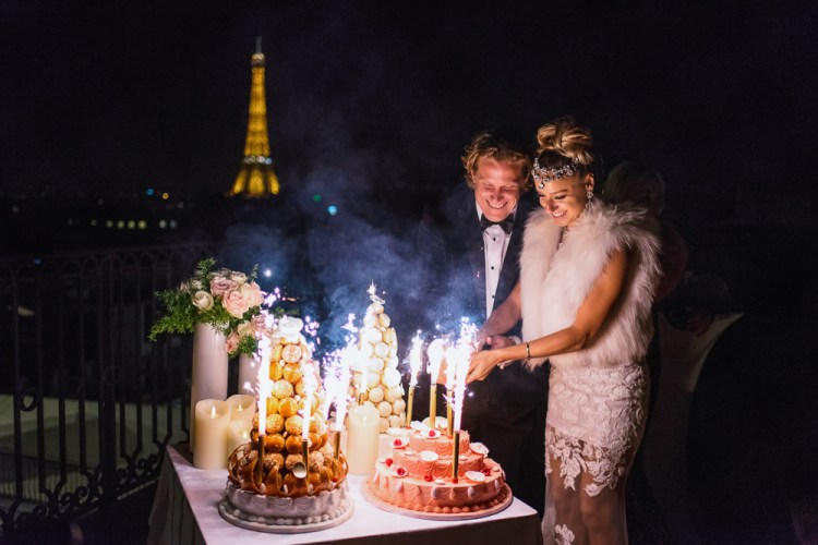 Bride and groom cutting wedding cake on their wedding night in Paris