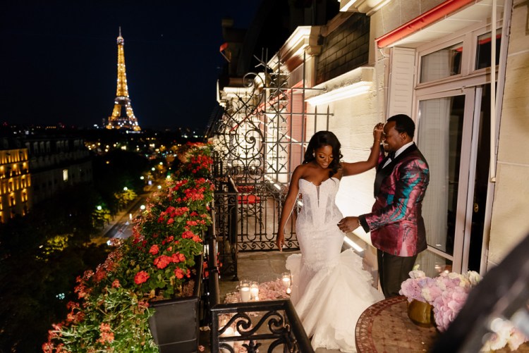 Bride and groom dancing on the terrace of their room at Plaza Athenee, overlooking the Eiffel Tower