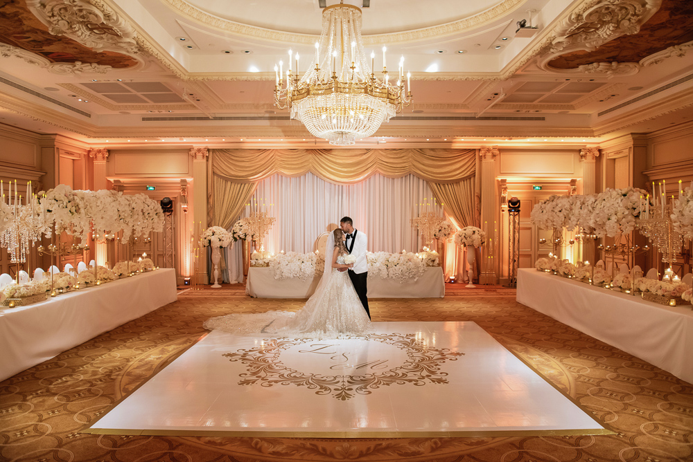 Bride and groom kissing in their wedding ballroom in France