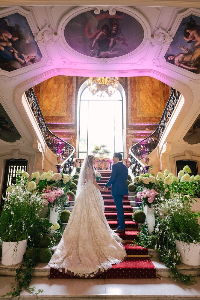 Bride and groom on the stairs of Hotel le Marois on their elopement day in Paris