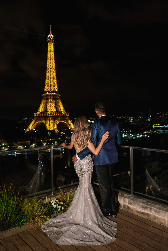 Bride and groom watching the Eiffel on their wedding night