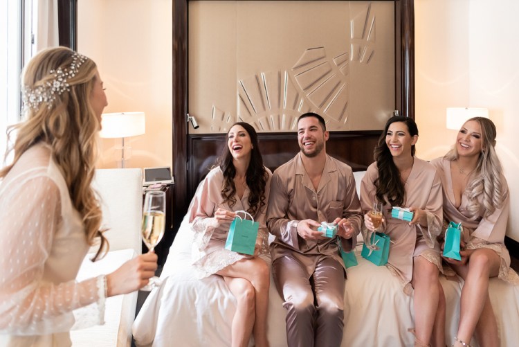Bridesmaids opening gifts from Paris bride on wedding day at The Peninsula Paris