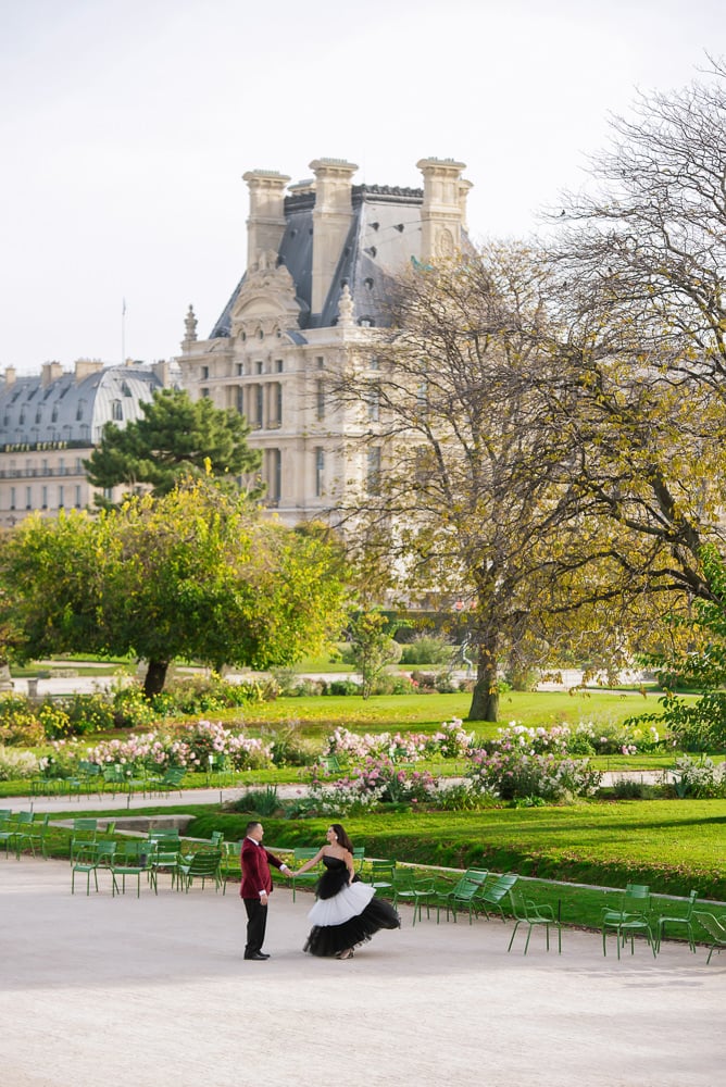 Young couple dancing in the Tuileries gardens, she is wearing Carolina Herrera dress