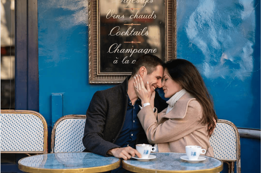 man and woman hugging and drinking coffee in a romantic restaurant in Paris