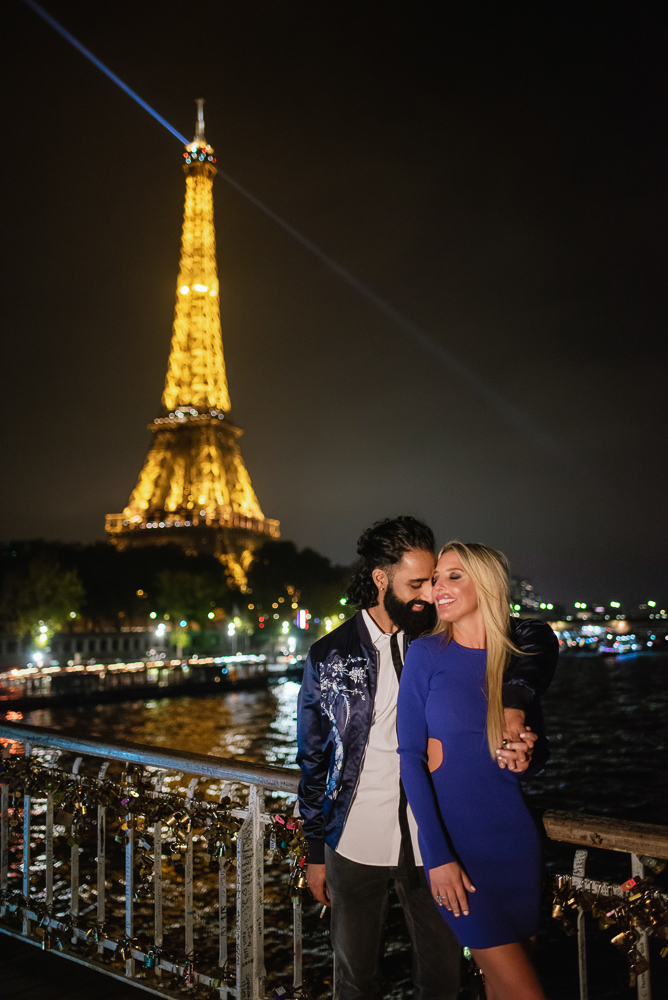 Couple in love by the eiffel tower at night