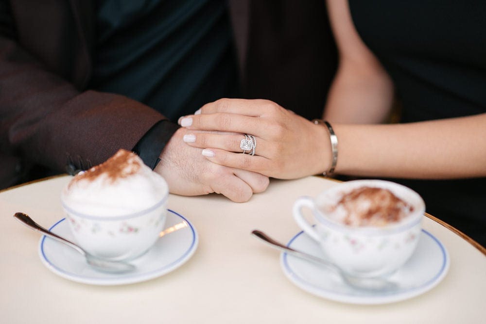 Cute close-up of holding hands and showing engagement ring