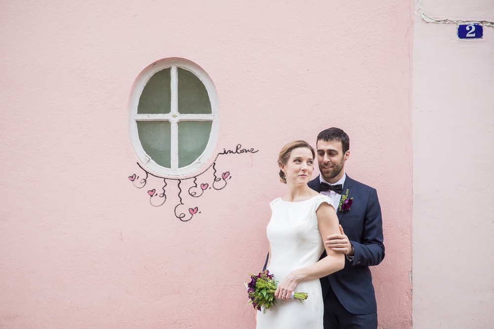 Bride and groom posing at La Maison Rose in Montmartre