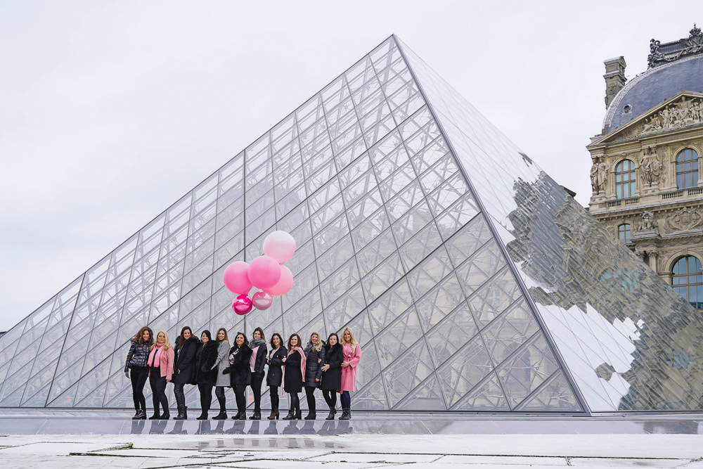 Exploring the Louvre Museum with pink balloons in hand