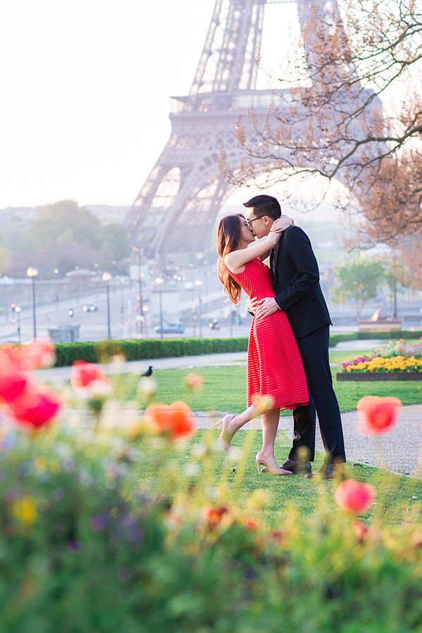 Girl in red dress kissing her fiance