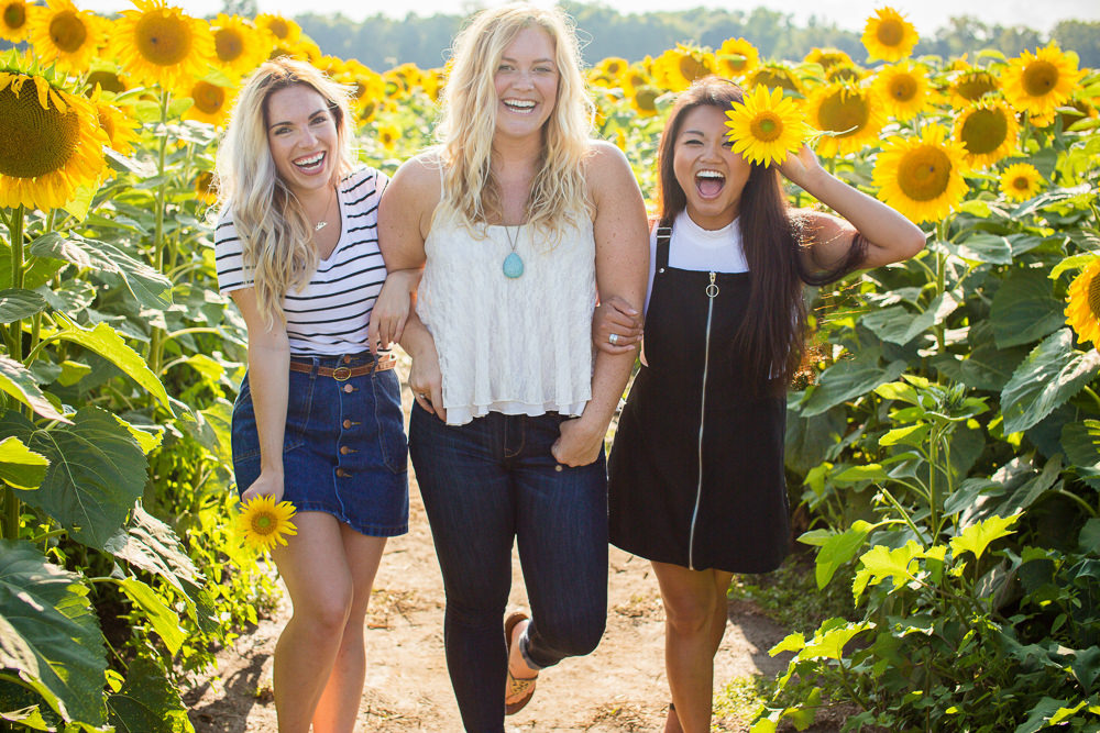 Girls spending time together in sunflower fields
