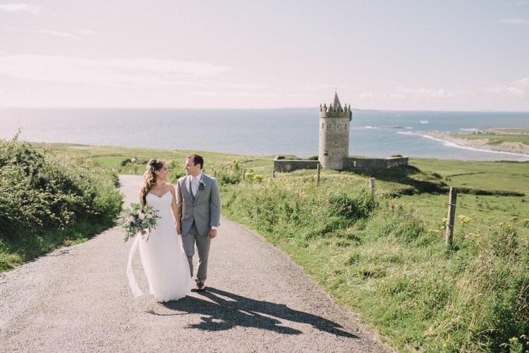 How to plan an elopement - Bride and groom walking hand in hand on a beach in Normandy France