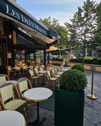 view of the sidewalk terrace of the restaurant Les Deux Magots in Paris