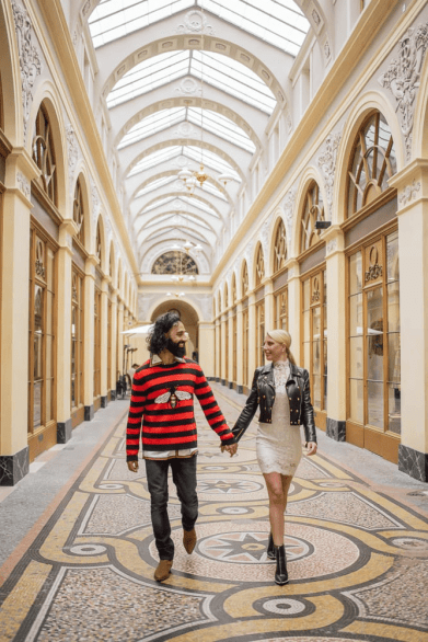 man and woman walking hand in hand in Galerie Vivienne