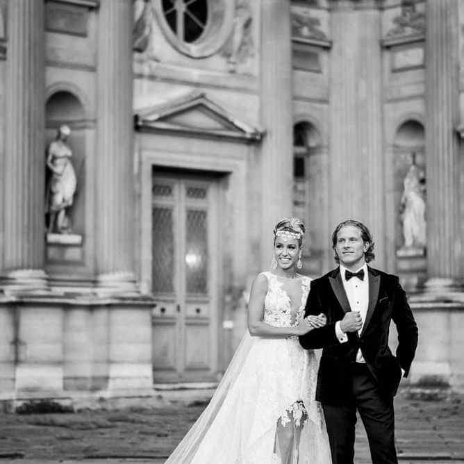 most romantic spots in paris bride and groom walking in the square courtyard of the louvre museum