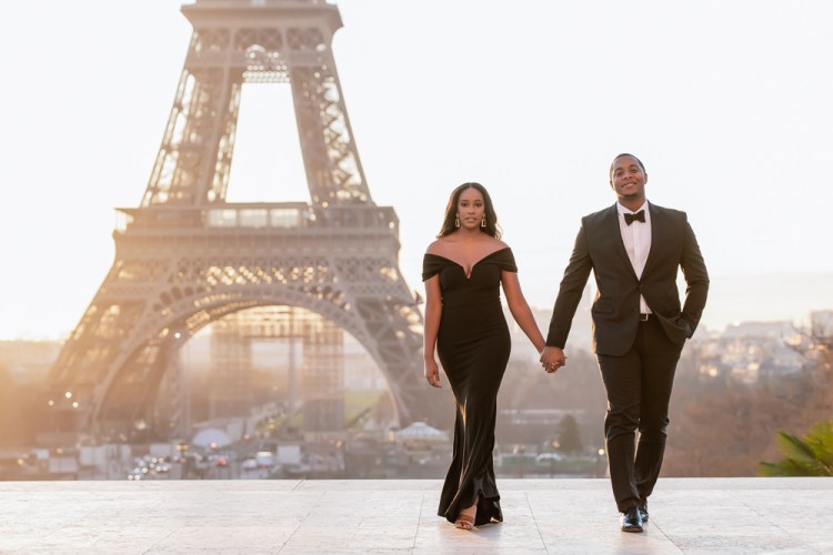 Newly engaged couple pose for their Paris photo shoot in elegant black outfits