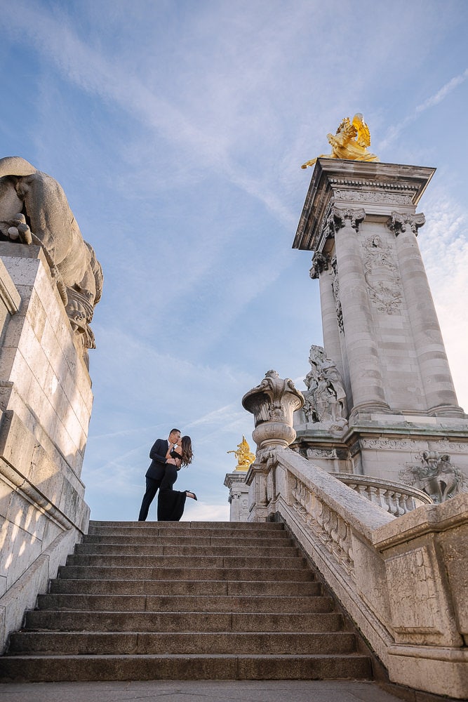 man and woman hugging on top of the stairs