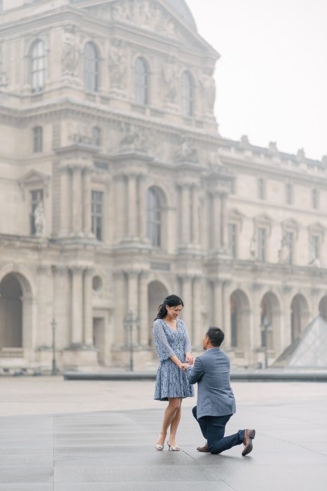 Paris proposal photographer - asian man one one knee proposing in the Louvre Museum courtyard