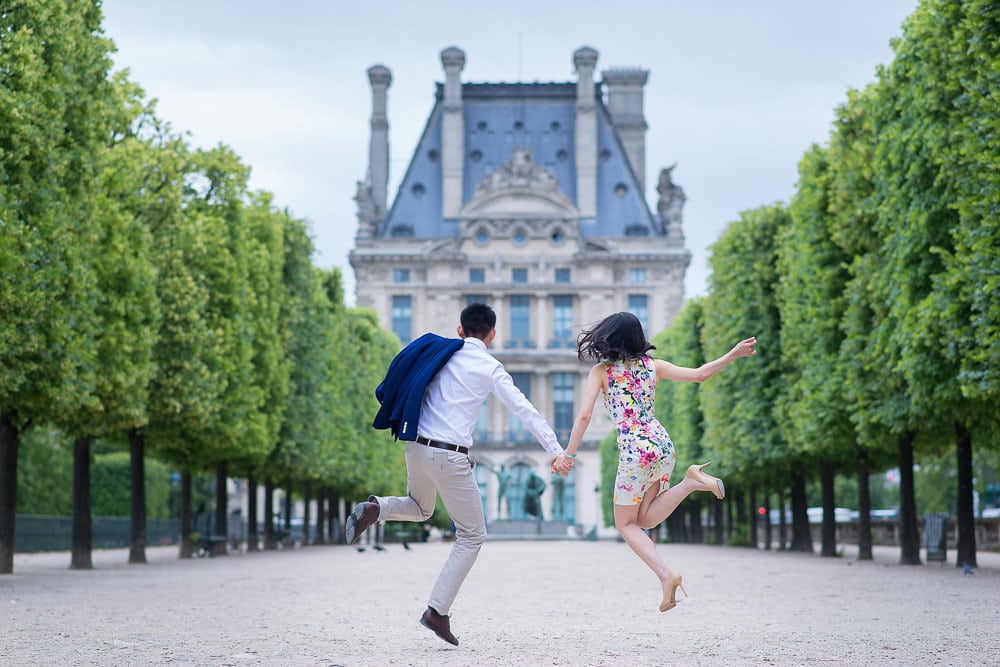 Couple jumping in the air in their fun photoshoot outfit