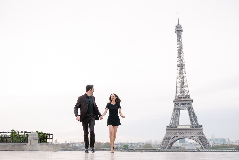 picture ideas for couples - young couple running towards the camera in Paris, France