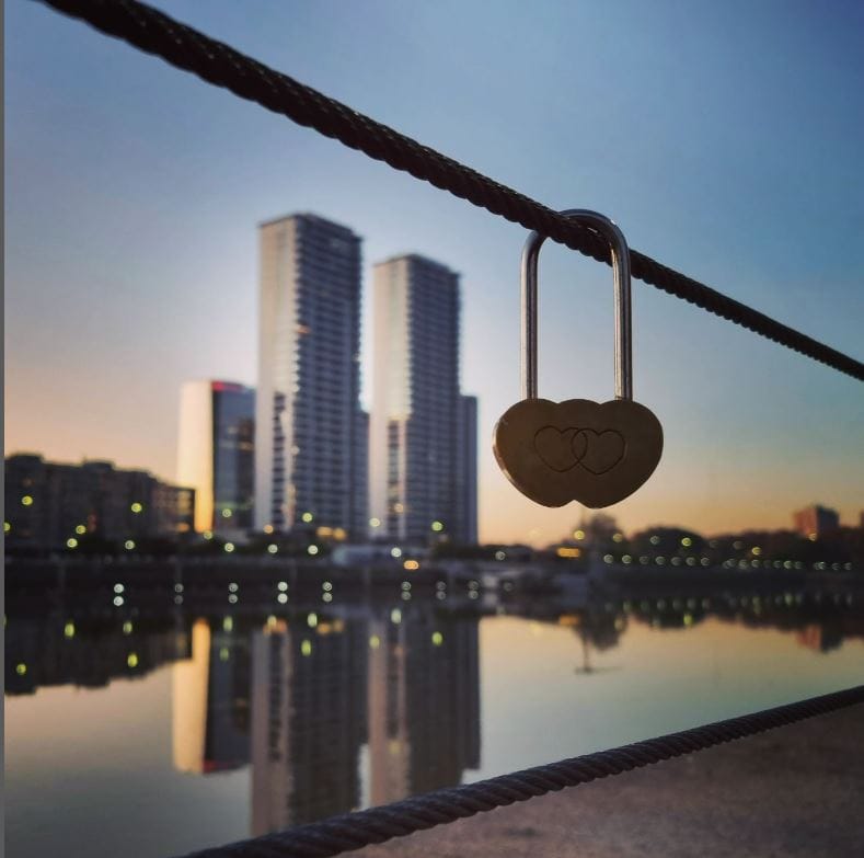 Ponte des Artes with two big buildings in the back and a love lock