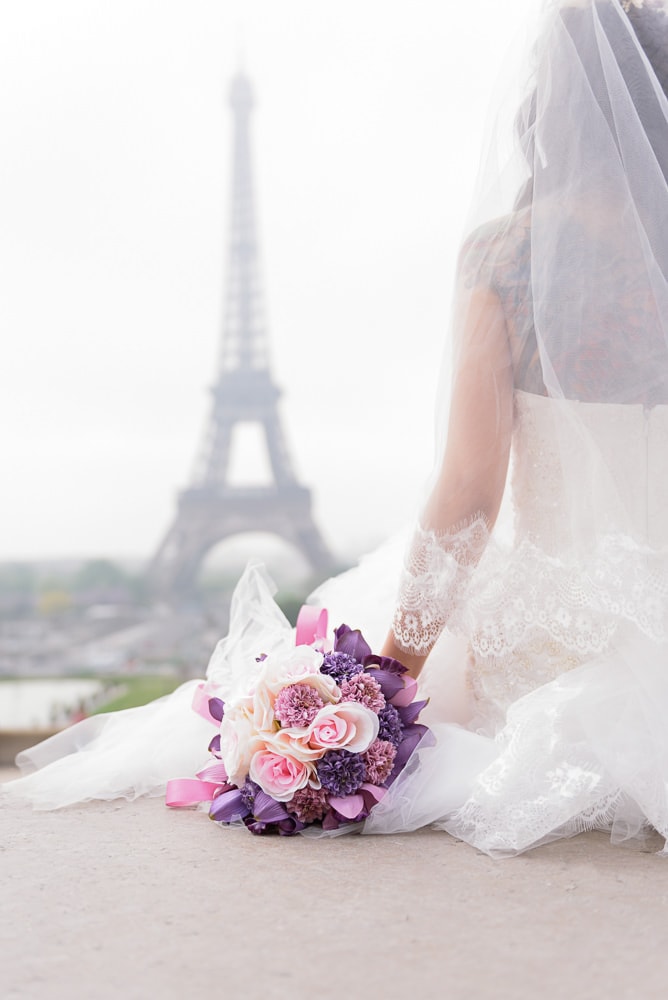 pre wedding photo close up of wedding bouquet at the eiffel tower in paris