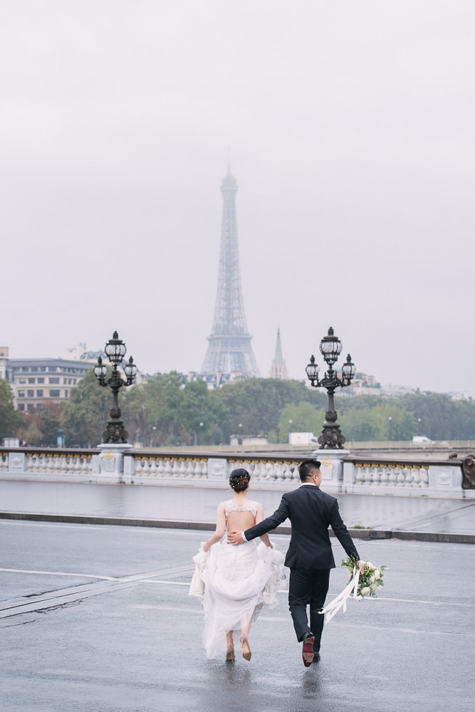 pre wedding photo concept bride and groom running across the street in paris