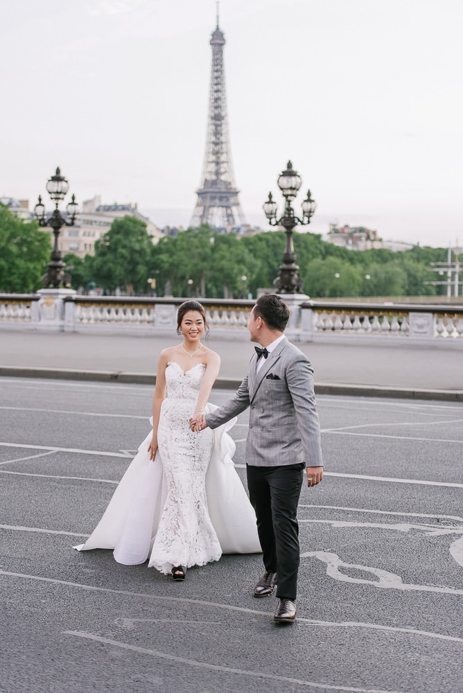 pre wedding pictures poses - bride and groom crossing the street in Paris -full