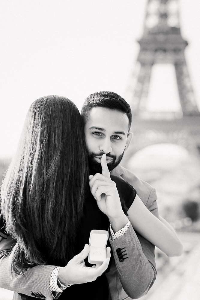 proposal in paris - iconic picture with a gentleman holding a secret - probably the most replicated image in paris
