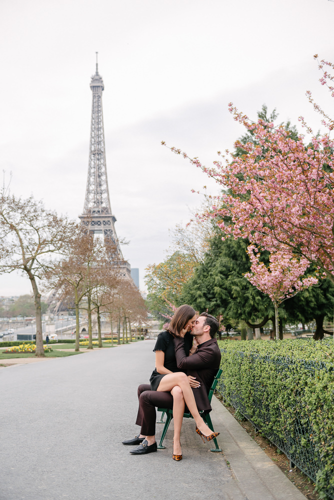 Romantic kiss on a bench in front of the Eiffel Tower