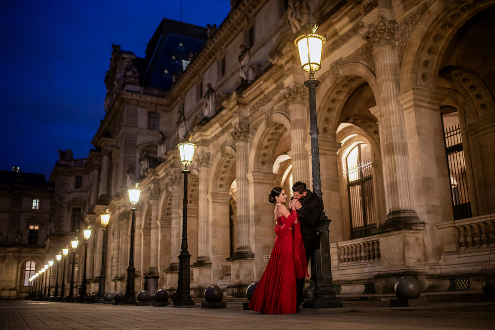 Romantic man kissing his girlfriends hand at night in Paris