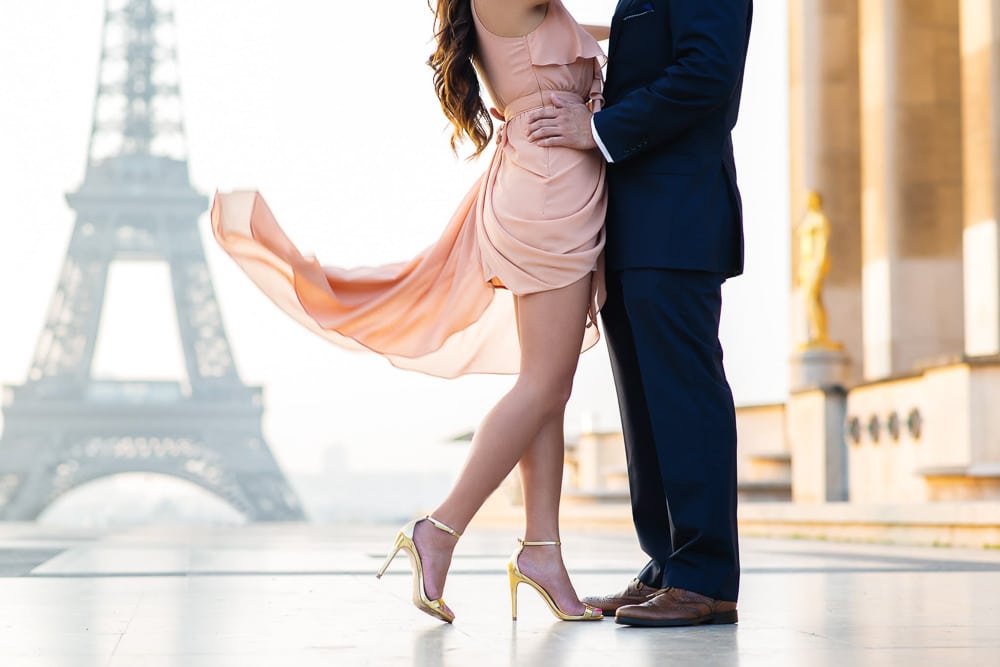 Romantic picture with a flowy dress in front of the Eiffel Tower