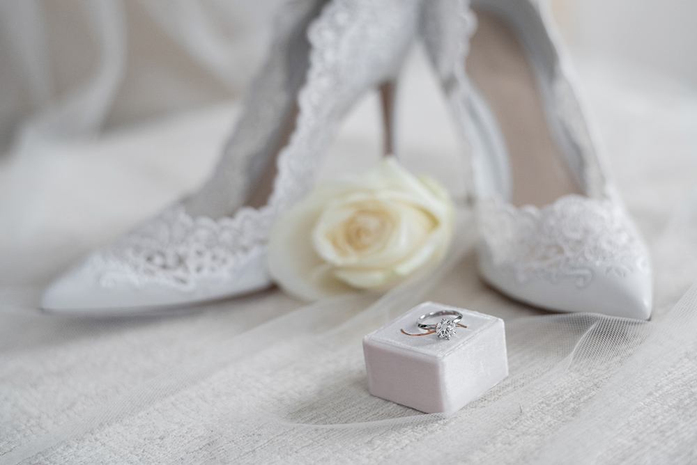 Wedding ring and whote wedding shoes
