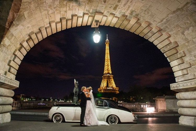 White Rolls Royce, the Eiffel Tower by night and a newly wed couple kissing passionately